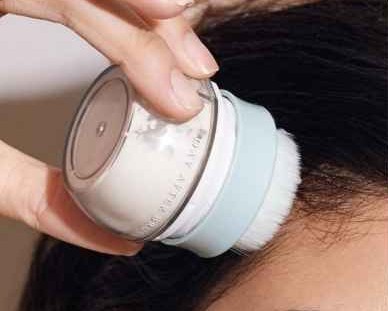 Applying the Day After™ Brush at the roots